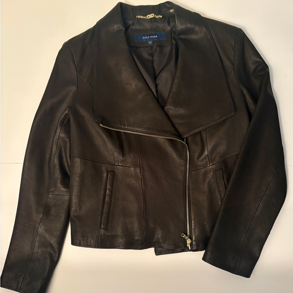 Cole Haan Women’s Black Leather Jacket, size L. Asymmetrical gold zipper. New